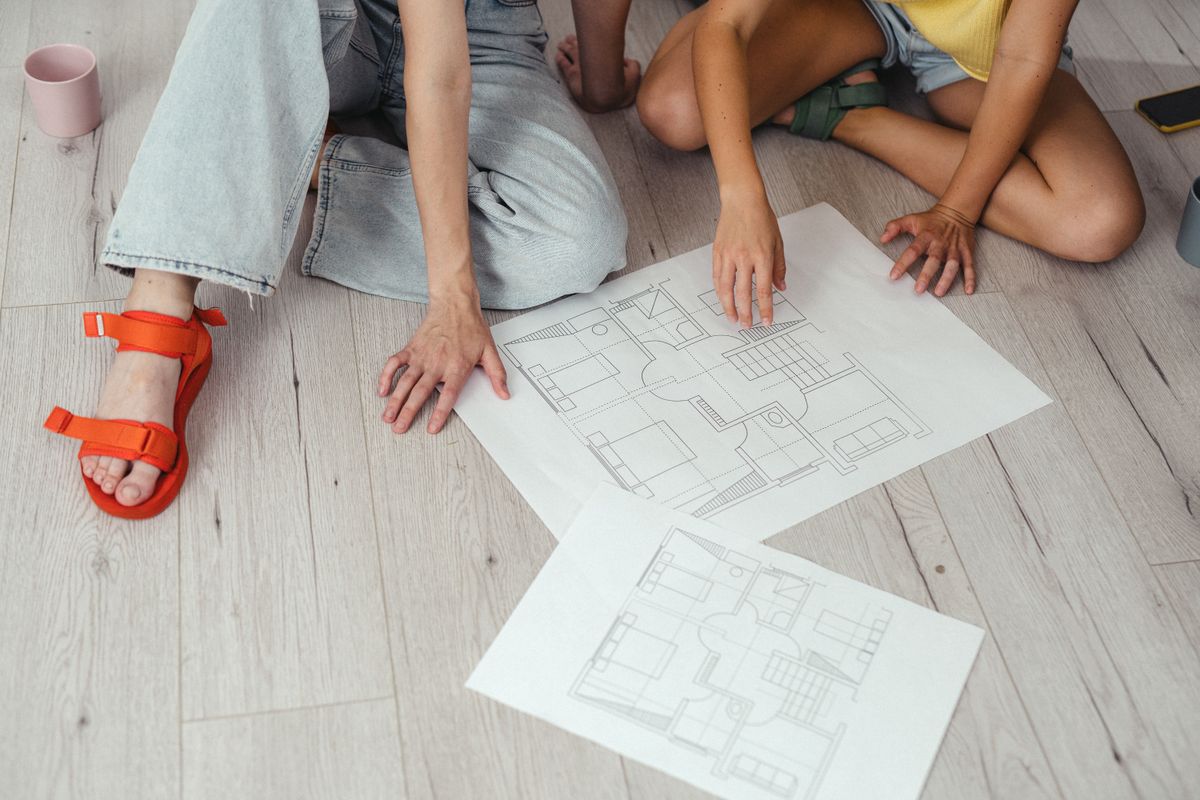 Two people reviewing a home floor plan together