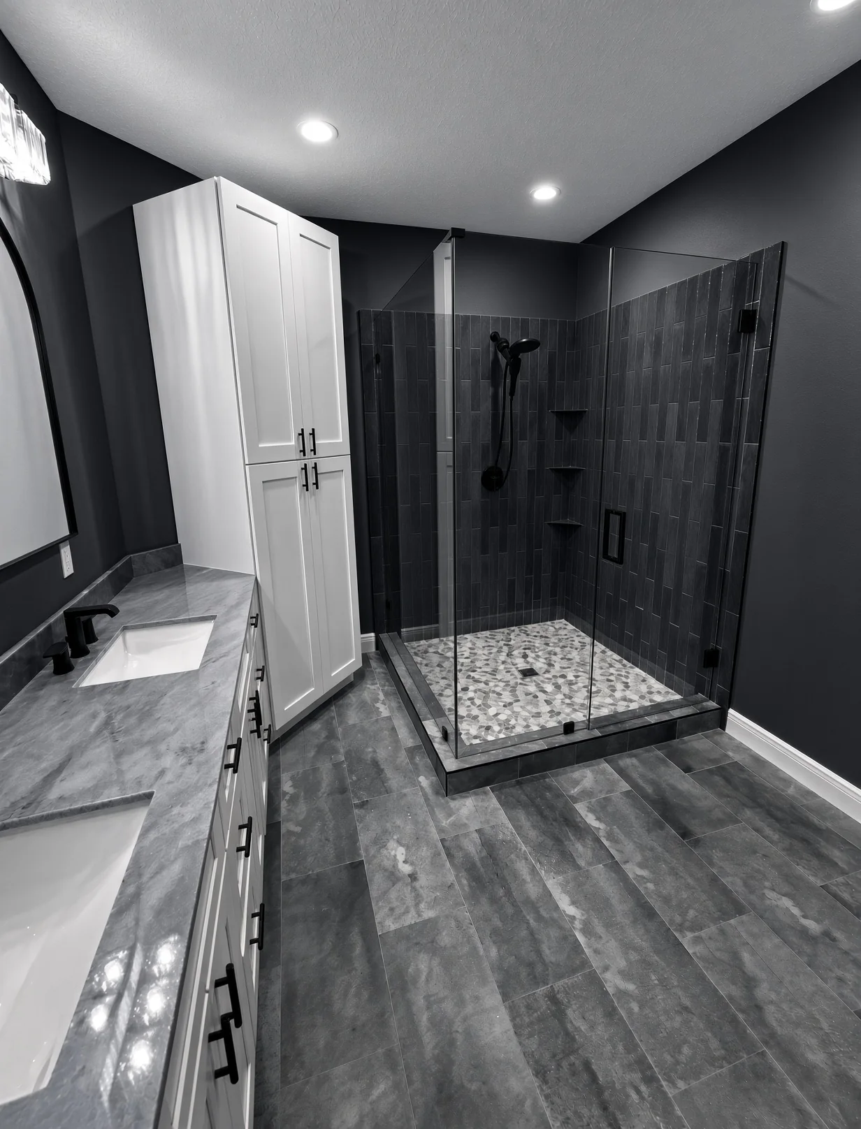 Walk-in glass shower with dark tile walls and a pebble floor