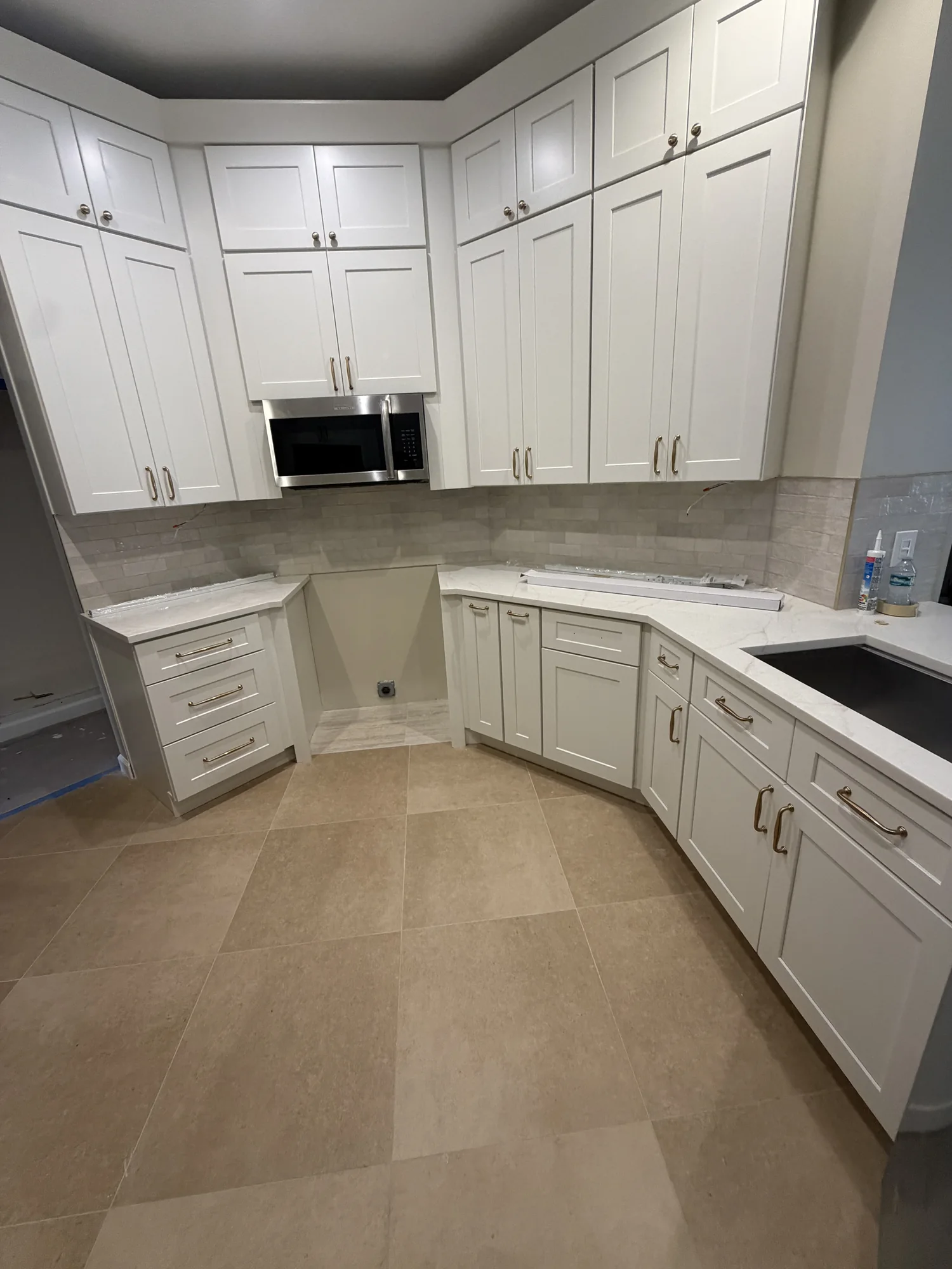 White shaker kitchen cabinets installed before the countertops