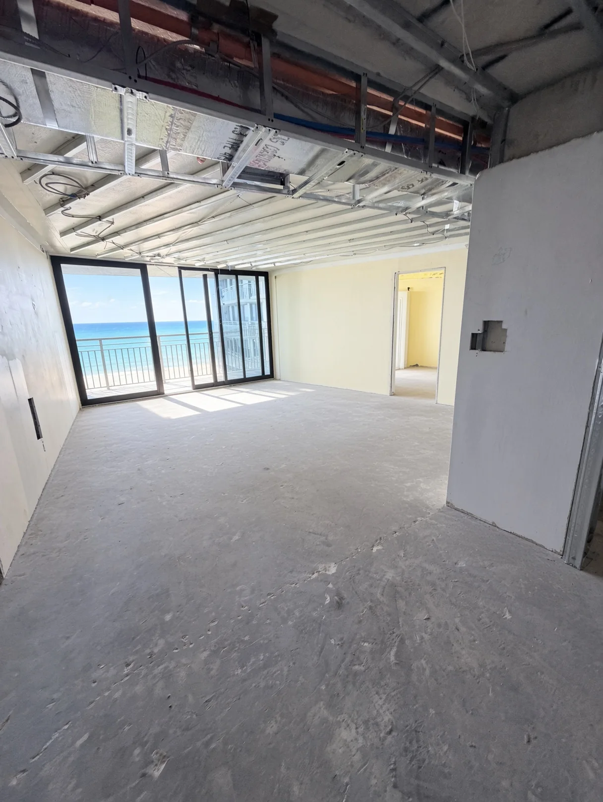 Ocean-view unit stripped to the slab and ceiling framing